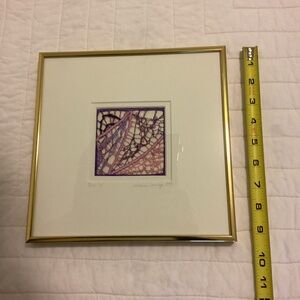 Square framed picture of fiber artwork.
